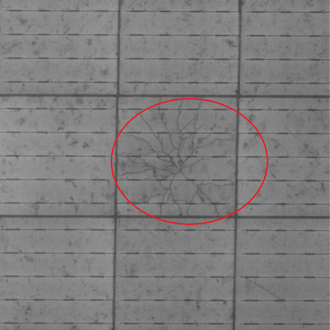 A red circle on the tile floor, indicating a crack in a solar panel.